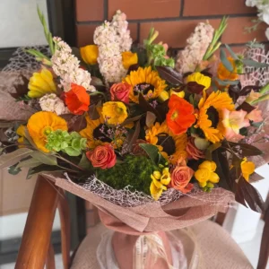 Sunset Glow orange and yellow bouquet with sunflowers, roses and seasonal flowers