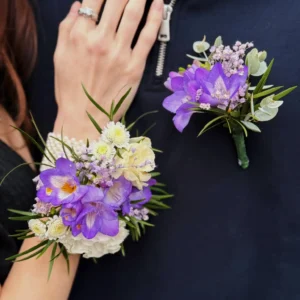 Matching wrist corsage and buttonhole set with fresh seasonal flowers