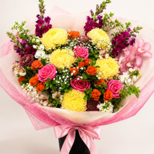 Colourful bouquet with yellow chrysanthemums, pink roses and orange seasonal flowers