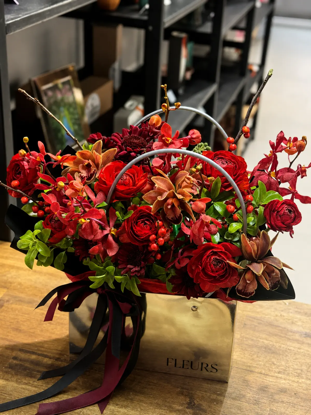 Luxury red and burgundy orchid flower arrangement in a gold bag by Camellia & Co Auckland.