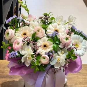 Pastel orchid, ranunculus and gerbera flower box arranged by Camellia & Co Auckland florist.