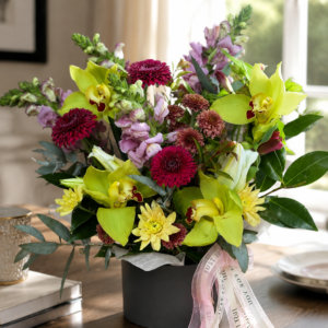 Vibrant pink and purple mixed flower bouquet with roses, iris and seasonal blooms