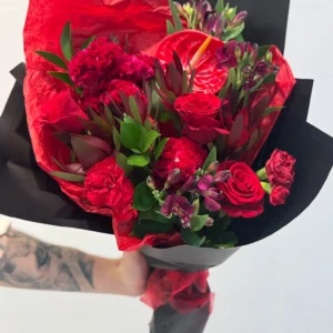Bold red bouquet with roses, carnations, anthurium and greenery