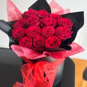 Bouquet of red roses wrapped in black and red paper