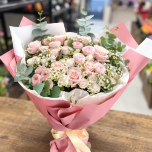 Rose Cloud pink rose bouquet with eucalyptus and white daisy-like flowers